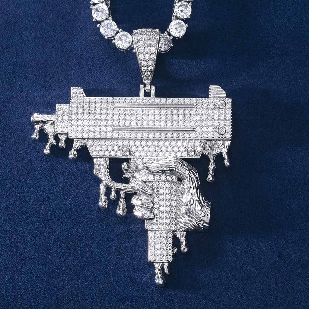 Hand Holding Dripping Gun Pendant In White Gold With Street Luxury Shine